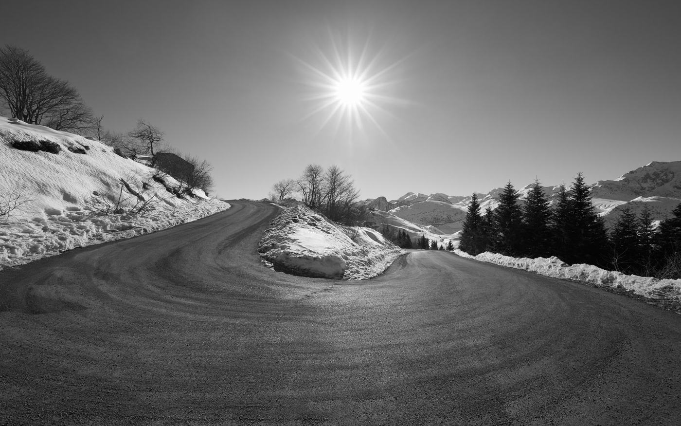 A mountain road curving towards the horizon